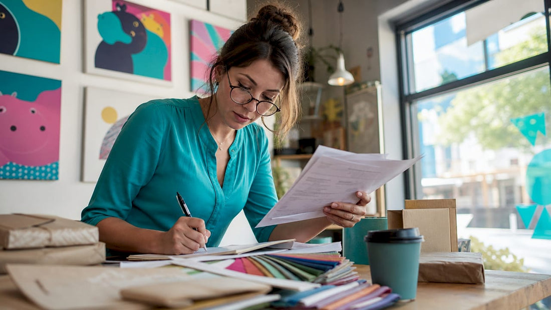 Decorator reviewing orders at warehouse office